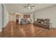 Open-concept living room with hardwood floors and views into the kitchen at 42396 Glen Abbey Dr, Elizabeth, CO 80107