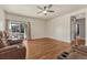 Cozy living room with hardwood floors, neutral walls, and sliding door access to the backyard at 42396 Glen Abbey Dr, Elizabeth, CO 80107