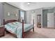 Main bedroom with carpeted floor, ceiling fan, and access to ensuite bathroom at 42396 Glen Abbey Dr, Elizabeth, CO 80107