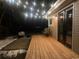 Back porch illuminated at night with deck and outdoor seating at 1150 W Caley Ave, Littleton, CO 80120