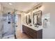 Modern bathroom with double vanity and walk-in shower at 1150 W Caley Ave, Littleton, CO 80120