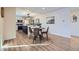 Dining area with wood flooring and seating, adjacent to the modern kitchen creating a welcoming and open space at 1150 W Caley Ave, Littleton, CO 80120