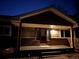 Night view of house exterior, showcasing entryway and porch at 1150 W Caley Ave, Littleton, CO 80120