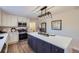 Renovated kitchen featuring a navy island and white shaker cabinets at 1150 W Caley Ave, Littleton, CO 80120