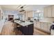 Updated kitchen featuring an island, stainless steel appliances, and bright finishes open to the adjacent living space at 1150 W Caley Ave, Littleton, CO 80120