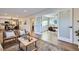 Open-concept living area connecting to a modern kitchen, showcasing wood floors and stylish furnishings at 1150 W Caley Ave, Littleton, CO 80120