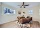 Bright office featuring a modern ceiling fan, hardwood floors, a cowhide rug, and natural light through windows at 1150 W Caley Ave, Littleton, CO 80120