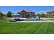 Aerial of backyard featuring a pool, slide, patio seating, and lush green lawn at 1315 W 141St Cir, Westminster, CO 80023