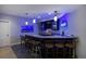 Basement bar featuring a granite countertop, dark cabinetry, and decorative lighting at 1315 W 141St Cir, Westminster, CO 80023