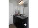 Bathroom featuring dark vanity, granite countertops, decorative tile, and modern fixtures at 1315 W 141St Cir, Westminster, CO 80023