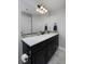 Bathroom vanity features a white countertop, dark cabinets, and a modern framed mirror at 1315 W 141St Cir, Westminster, CO 80023