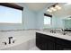 Stylish bathroom featuring a soaking tub and vanity with dark wood cabinets at 1315 W 141St Cir, Westminster, CO 80023