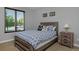 Cozy bedroom features a queen-size bed, wood floors, and ample natural light from the large window at 1315 W 141St Cir, Westminster, CO 80023