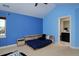 Bright blue bedroom features a bed with built-in shelving and an ensuite bathroom at 1315 W 141St Cir, Westminster, CO 80023