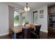 Bright dining room features hardwood floors, a rustic table, and sliding glass doors to the outdoors at 1315 W 141St Cir, Westminster, CO 80023