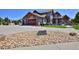 Home exterior showing a three-car garage, stone accents, and decorative rock landscaping at 1315 W 141St Cir, Westminster, CO 80023
