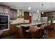 Gourmet kitchen features granite counters, stainless steel appliances, dark wood cabinetry, and barstool seating at 1315 W 141St Cir, Westminster, CO 80023