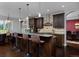Kitchen island with bar stool seating and pendant lighting, overlooking the dining area at 1315 W 141St Cir, Westminster, CO 80023