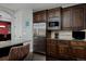 A close up of a gourmet kitchen with stainless steel appliances, dark wood cabinetry and granite countertops at 1315 W 141St Cir, Westminster, CO 80023