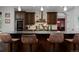 Kitchen island with granite counters, seating, stainless hood, and hardwood floors at 1315 W 141St Cir, Westminster, CO 80023