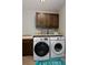 Functional laundry room includes modern washer and dryer, upper cabinets and countertop for folding and organizing at 1315 W 141St Cir, Westminster, CO 80023