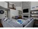Comfortable living room features a stone fireplace, entertainment center, with large windows and comfortable gray sectional seating at 1315 W 141St Cir, Westminster, CO 80023