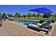 Backyard pool featuring a slide, lounge seating, a lawn and a safety fence at 1315 W 141St Cir, Westminster, CO 80023