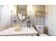 Vintage bathroom with bright wallpaper, stylish vanity, and modern fixtures at 2300 Joliet St, Aurora, CO 80010
