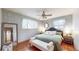 Cozy bedroom featuring hardwood floors, soft blue walls, and a king-size bed at 2300 Joliet St, Aurora, CO 80010