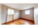 Bright bedroom featuring hardwood floors, neutral walls, and well-lit by two windows at 2300 Joliet St, Aurora, CO 80010