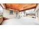 Back porch featuring a covered area with concrete flooring, steps to a door, and access to the yard at 2300 Joliet St, Aurora, CO 80010