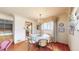 Cozy dining area featuring hardwood floors, chandelier lighting, and a view into the adjacent kitchen at 2300 Joliet St, Aurora, CO 80010