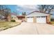 Charming brick home with a two-car garage and covered front porch, set on a well-maintained lawn at 2300 Joliet St, Aurora, CO 80010