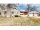 Back and side view of a ranch style brick home with a two-car garage and covered patio at 2300 Joliet St, Aurora, CO 80010