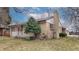 Single story brick house showing lawn with small evergreen tree at 2300 Joliet St, Aurora, CO 80010