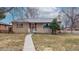 Charming single-story brick home with manicured lawn and inviting entrance at 2300 Joliet St, Aurora, CO 80010