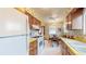 Nostalgic eat-in kitchen featuring vintage floral wallpaper and light fixtures at 2300 Joliet St, Aurora, CO 80010