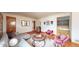 Bright and airy living room boasting hardwood floors, stylish furniture, and a large window at 2300 Joliet St, Aurora, CO 80010
