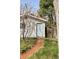Charming backyard access with a brick pathway leading to a quaint, light-blue door at 309 S Hudson St, Denver, CO 80246