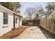 Fenced backyard area featuring a concrete slab and some surrounding trees at 309 S Hudson St, Denver, CO 80246