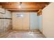 Unfinished basement with wooden ceiling beams and a small window at 309 S Hudson St, Denver, CO 80246