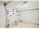 Basement with water heater and brick wall at 309 S Hudson St, Denver, CO 80246