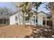 Charming home featuring a white brick exterior and mature trees in the front yard at 309 S Hudson St, Denver, CO 80246