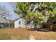 Charming home featuring a white brick exterior and mature trees in the front yard at 309 S Hudson St, Denver, CO 80246