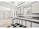 Bright kitchen featuring contrasting black and white cabinets and a breakfast bar at 309 S Hudson St, Denver, CO 80246
