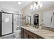 Bathroom with granite countertops, modern fixtures, and a glass-enclosed shower at 23539 E Ida Dr # C, Aurora, CO 80016