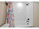 Clean bathroom featuring a white tile shower, a colorful shower curtain, and modern fixtures at 23539 E Ida Dr # C, Aurora, CO 80016