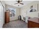 Bedroom features a ceiling fan, a large window and carpeted floors at 23539 E Ida Dr # C, Aurora, CO 80016