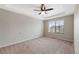 Spacious bedroom with tray ceiling, fan, and a view of the neighborhood at 23539 E Ida Dr # C, Aurora, CO 80016