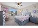Bedroom featuring soft carpeting, large window, and blue furniture at 23539 E Ida Dr # C, Aurora, CO 80016